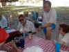 6-S-Stevie_and_Roger_and_talking_around_the_picnic_table.jpg (158176 bytes)