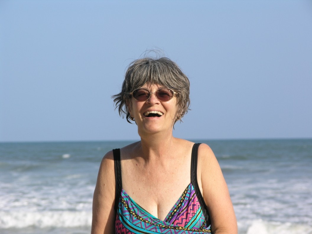 Kathleen laughing on the beach at Anomabu